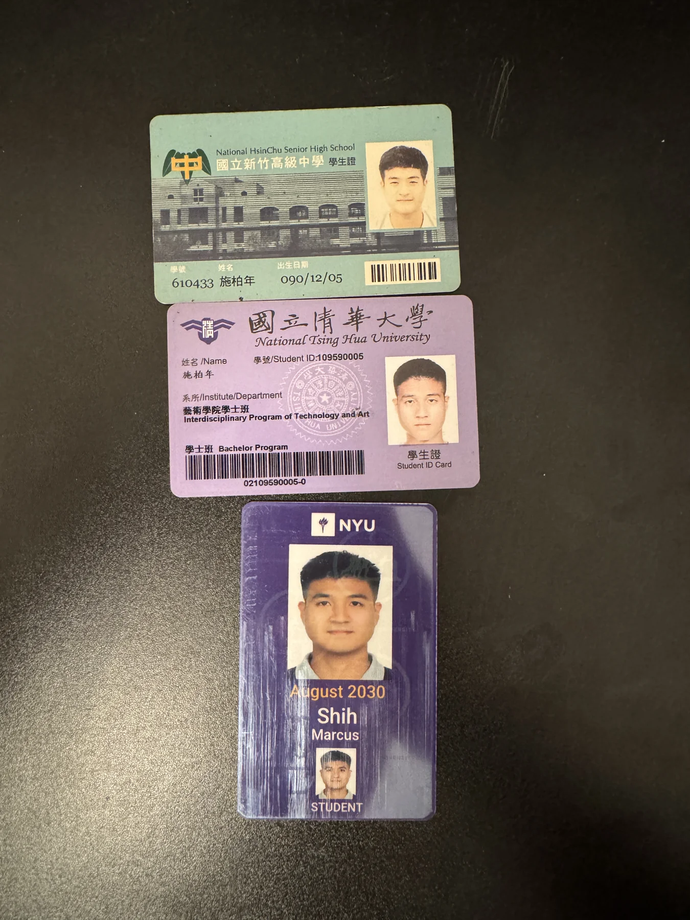 My high school, National Tsing Hua University, and NYU student IDs arranged together, front sides