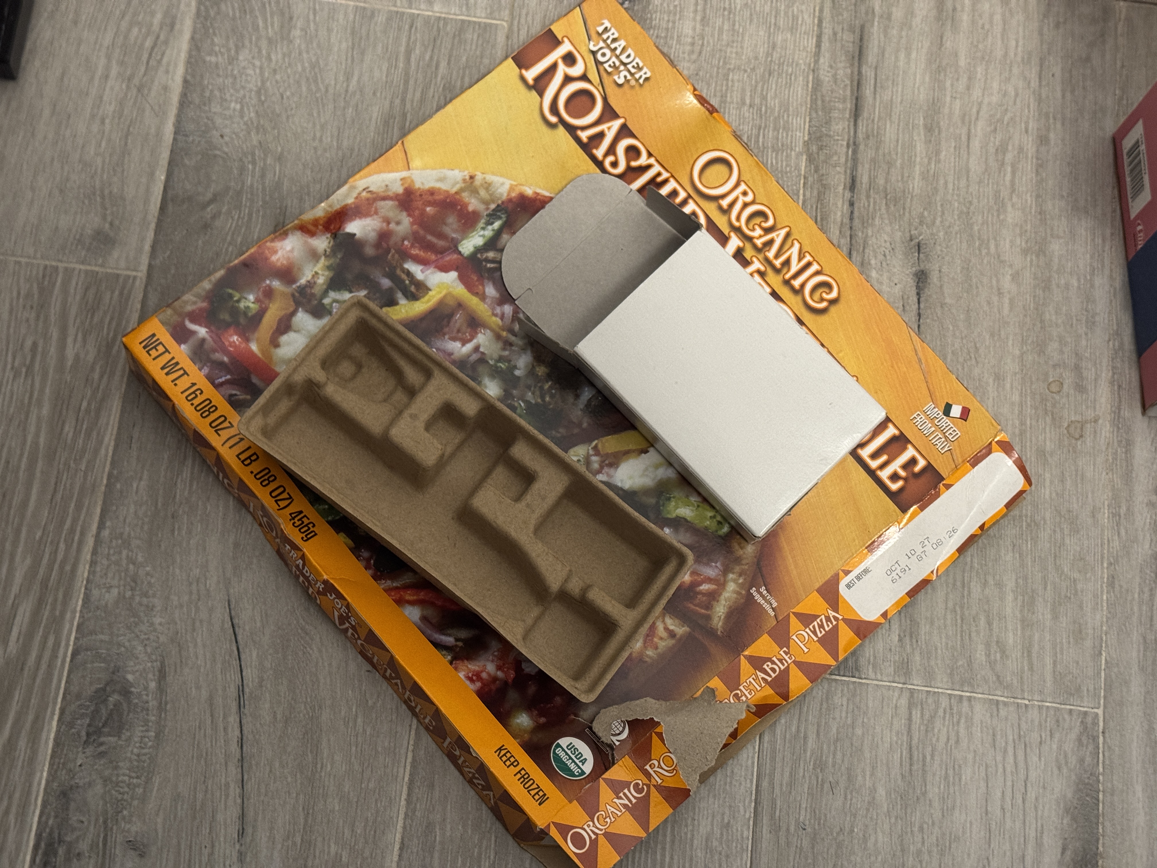 Discarded cardboard boxes, printed food packaging, paper packaging, and molded fiber pieces.