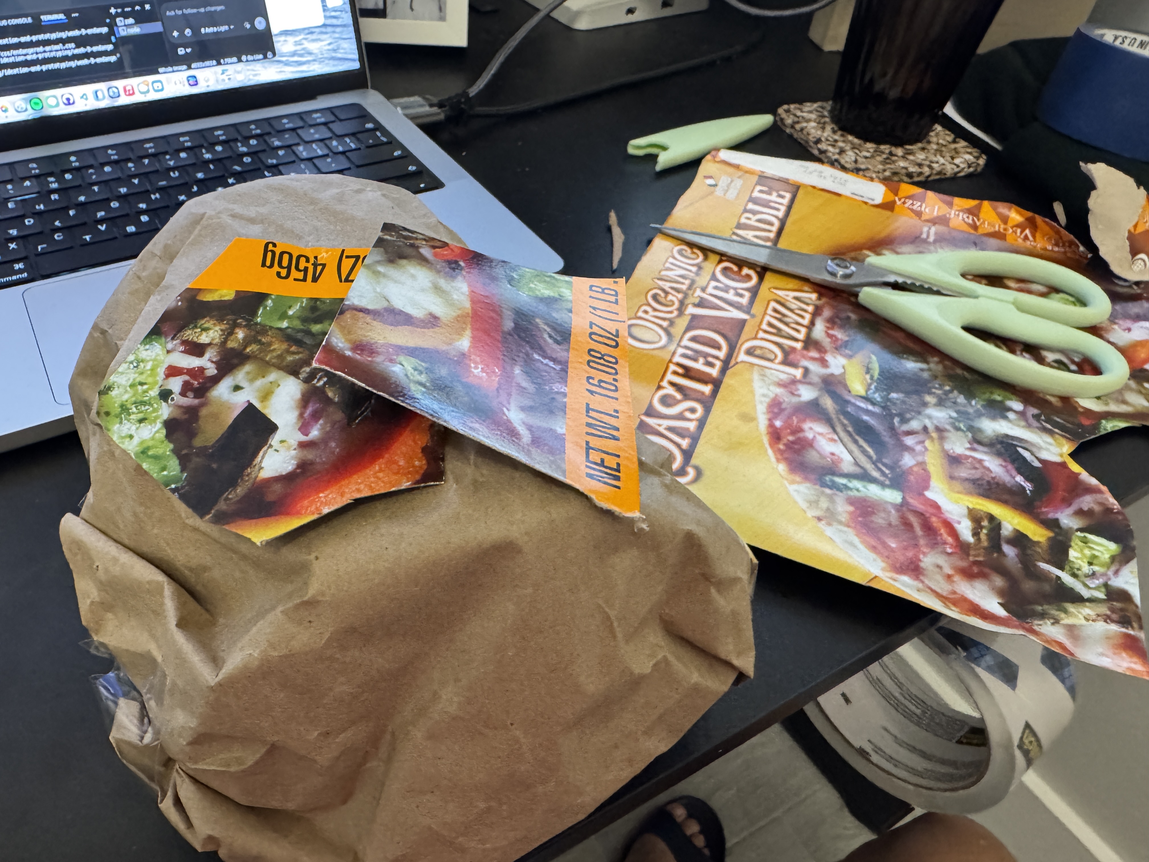 Brown paper turtle shell with colorful discarded food packaging being added to the top.