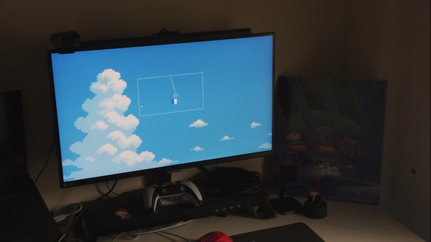 A virtual wind chime sways against a blue sky on a desktop monitor.
